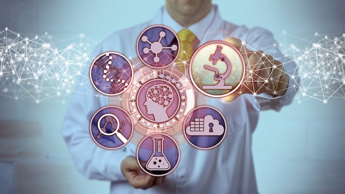 Unrecognizable male scientist is plugging a microscopy app into a brain study interface. Science concept for biosciences, molecular engineering, bioengineering, pharmacogenomics, pharmacogenetics.