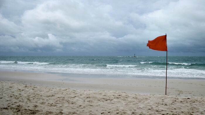 red warning flag on beach