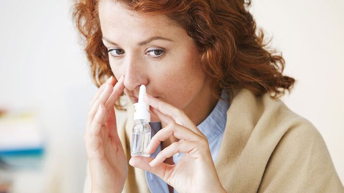 Woman Using Nose Spray