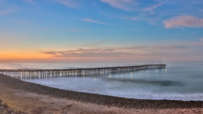 Sweeping view of a partly cloudy sunrise over the Ventura coastline