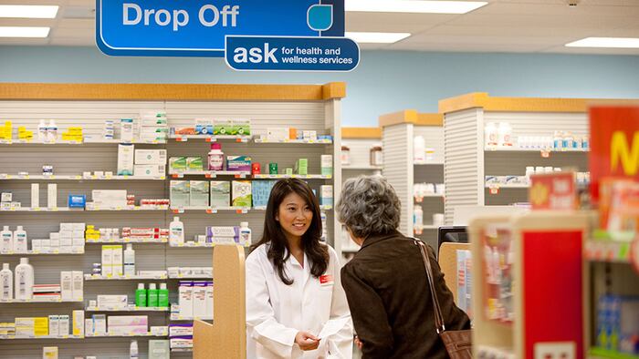 Female CVS retail pharmacist with patient