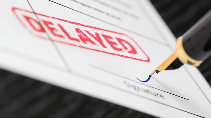 document with "delayed" stamped on it