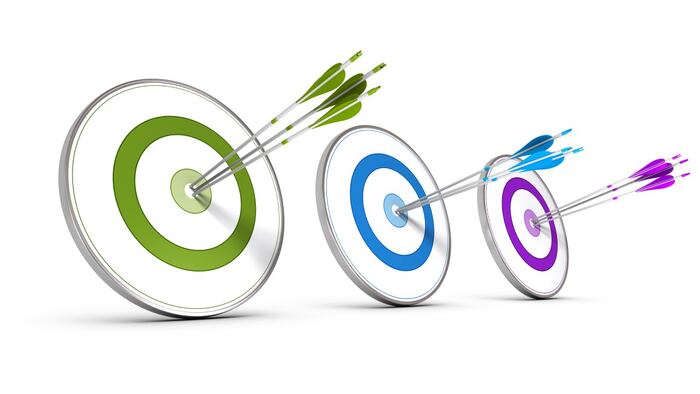 Three targets with arrows in the bullseye, green blue and purple