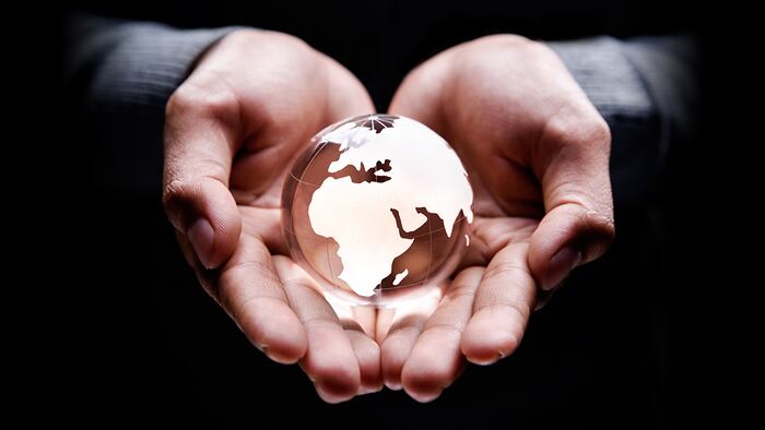 Globe hands (otnaydur/Shutterstock.com)