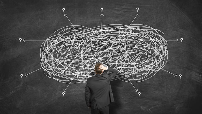 Businessman Looking At perplexed ways Searching For Solution.