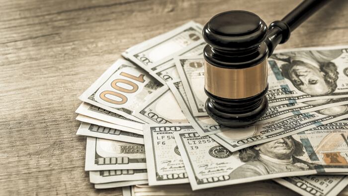 wooden gavel with usa dollar on desk. close up. toned image