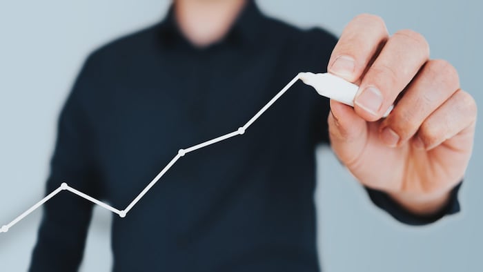 Growth man drawing graph pen