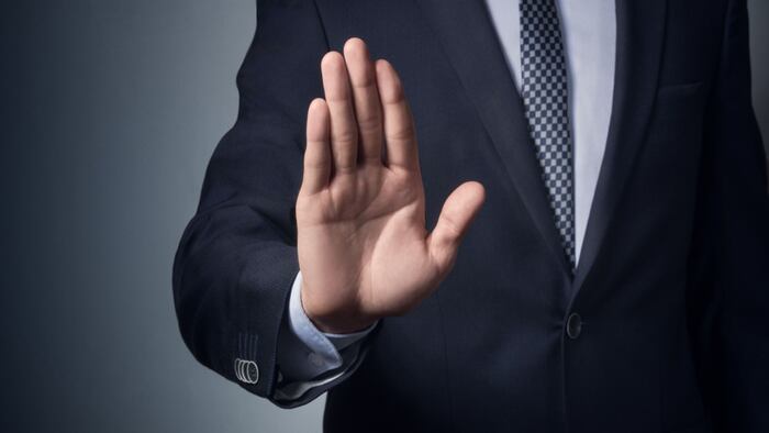 image of man in suit gesturing "no"