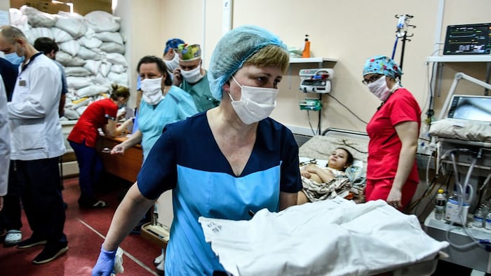 ZAPORIZHZHIA, UKRAINE - MARCH 18, 2022 - Healthcare providers stay by little patients at the Zaporizhzhia Regional Children's Clinical Hospital