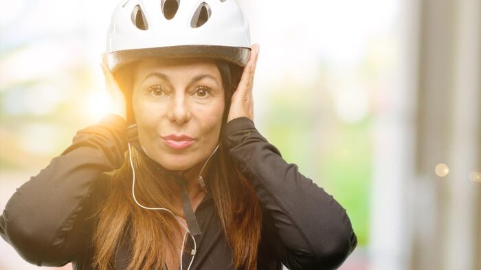 Woman covering her ears to block noise
