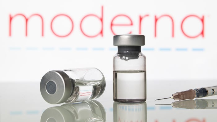 Vials and syringe with Moderna Inc logo