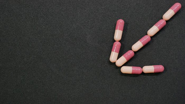 pink pills down arrow