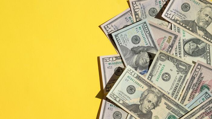 US dollars on yellow background