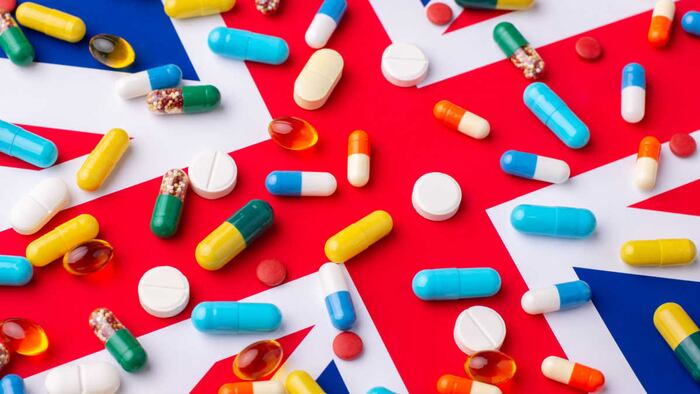Different pills and tablets on flag of United Kingdom.