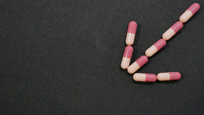 pink pills down arrow