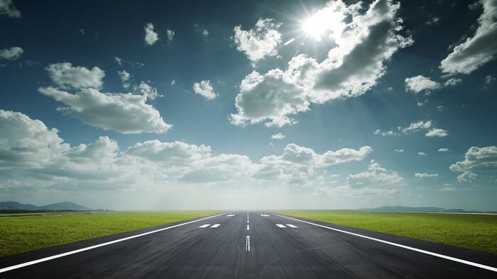airport runway under the sun as background