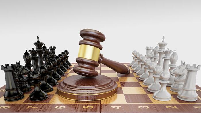 Gavel on chess board with figures. Law chess concept, 3D rendering