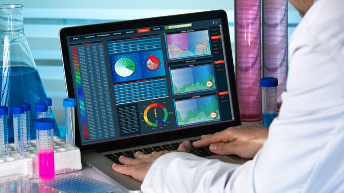 scientist working with laptop in lab / biomedical engineering working with computer in laboratory - Image