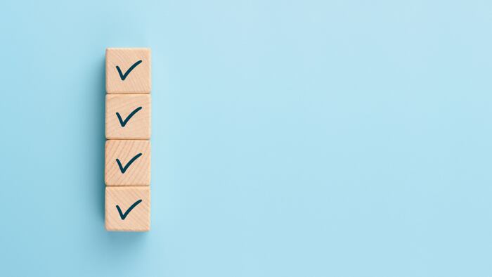 Check marks on four wooden blocks