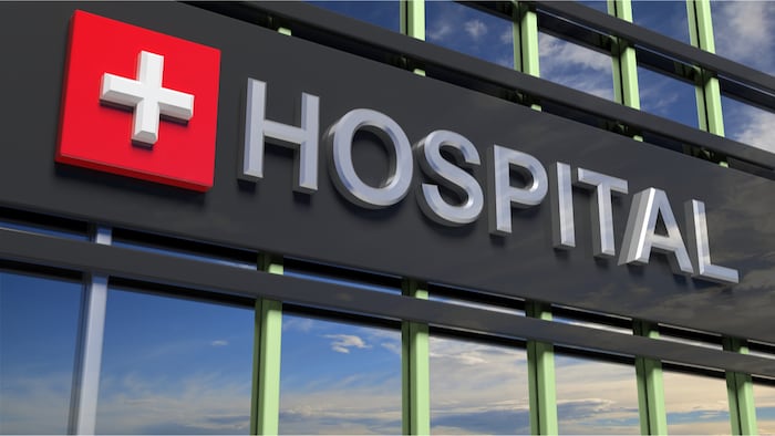 Hospital building sign closeup, with sky reflecting in the glass. 3d rendering