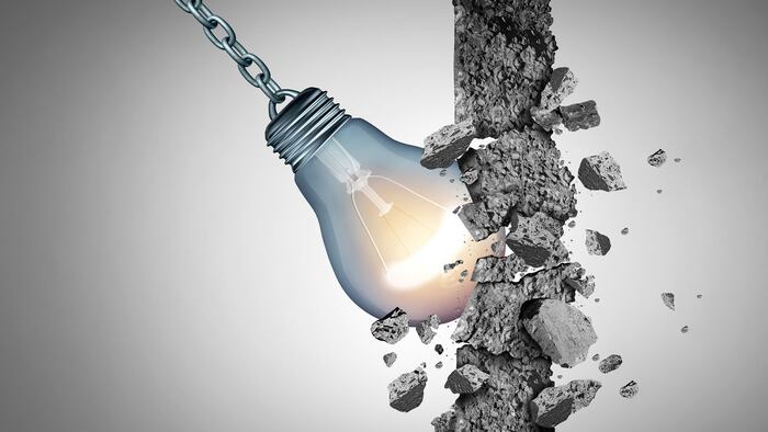 Idea breakthrough and the power to demolish an obstacle with creative thinking and innovative solutions as a light bulb shaped as a wrecking ball with 3D illustration elements. - Illustration