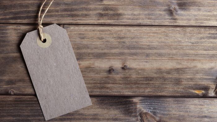 Brown price tag on wooden background