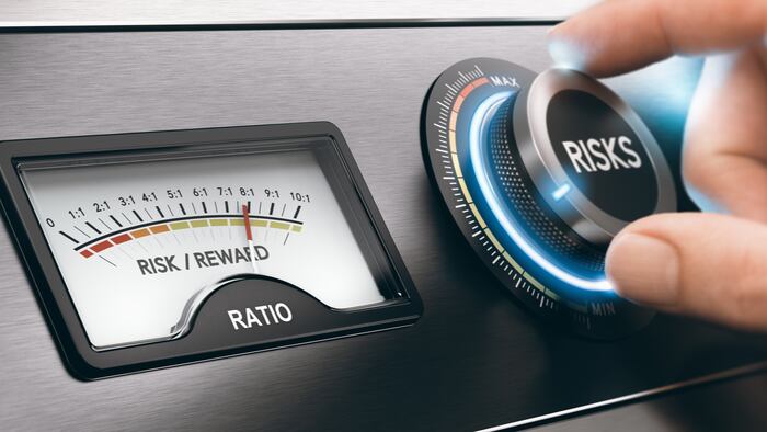 Hand turning a knob to select low risks investment. Concept of risk and reward ratio. Composite image between a hand photography and a 3D background.