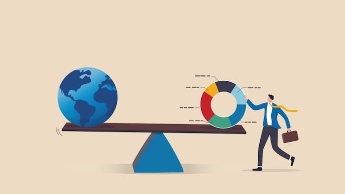 scale with globe on one side and a business man holding onto a circle graph divided into sections on the other.