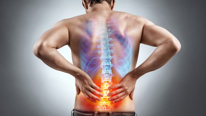 Lower back pain. Man holding his back in pain. Medical concept.