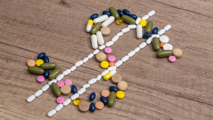 Dollar sign made with drug pills