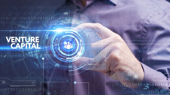 Business, Technology, Internet and network concept. Young businessman working on a virtual screen of the future and sees the inscription: venture capital