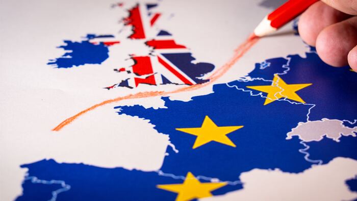 Hand drawing a red line between the UK and the rest of the European Union. Concept of Brexit. The UK is thus on course to leave the EU on 29 March 2019