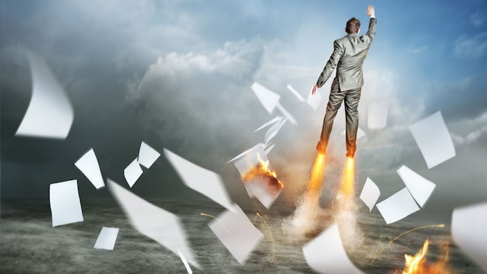 Businessman Success. A businessman launching upwards, paperwork flying everywhere!