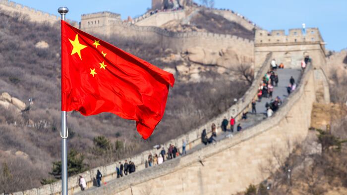 The Great Wall of China on the background and chinese red flag - Image