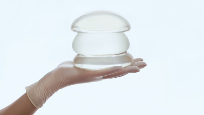 Silicone breast implant on hands - Image