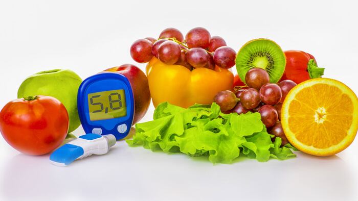 glucometer for glucose level and healthy organic food on a white background. Diabetes concept