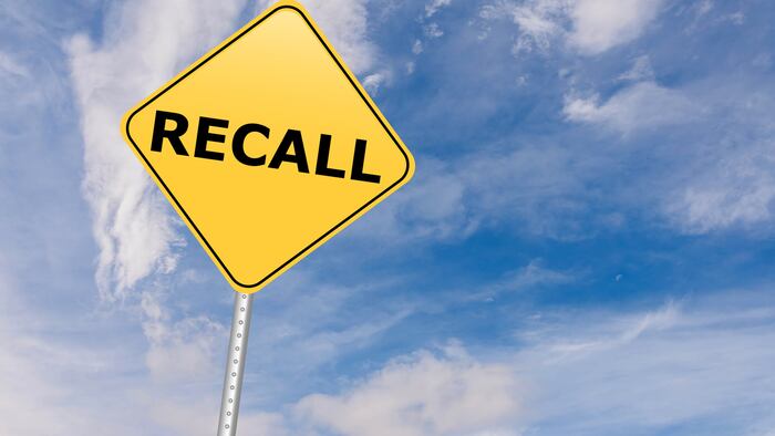 Recall Road Sign against sky.