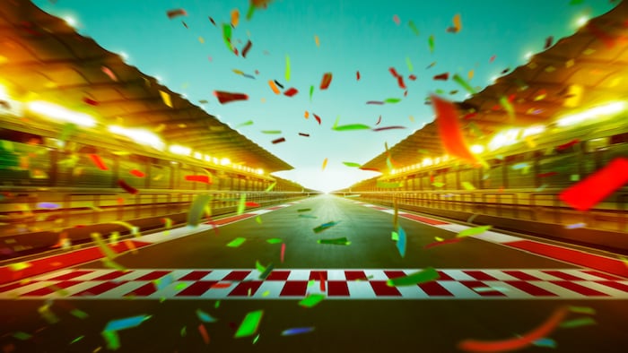 Night speedy motion blur international race track with starting finishing line and confetti