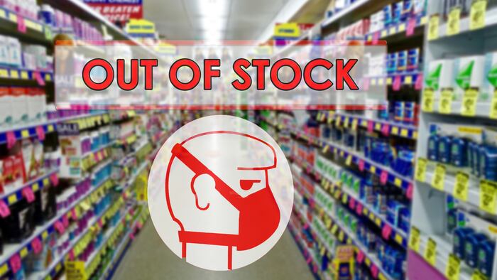 Concept of the impact and threat of the corona virus health crisis, protective hygienic masks out of stock in purposely blurred drugstore shelves