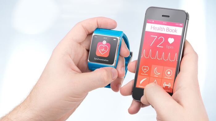 Data synchronization of health book between smartwatch and smartphone in male hands