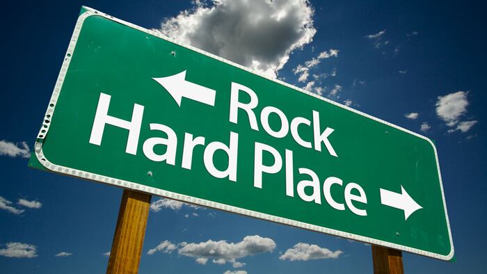 "Rock, Hard Place" Road Sign with dramatic clouds and sky.