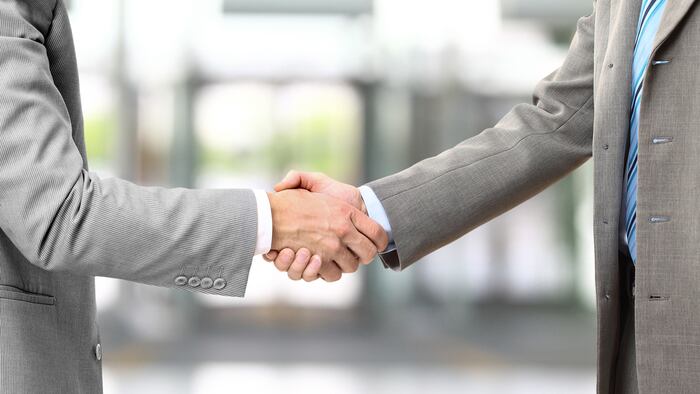 Photo of handshake of business partners after striking deal