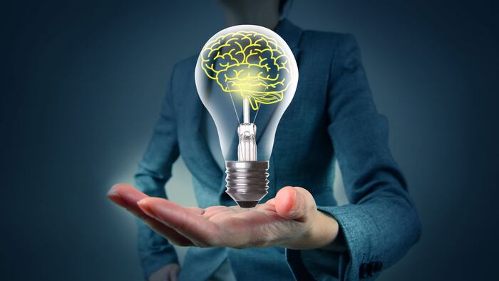 Light bulb in hand with brain