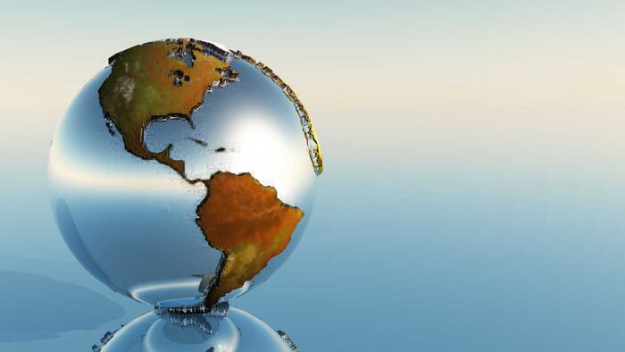 Glassy Globe, Showing The Americas, Set Against A Pale Gradient Background