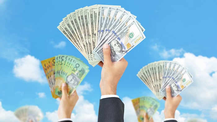 Hands holding money in multi currencies