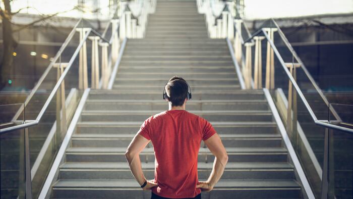 Man in red shirt preparing for stair run