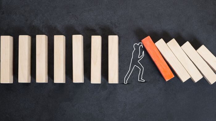 Man Holding Up Falling Blocks
