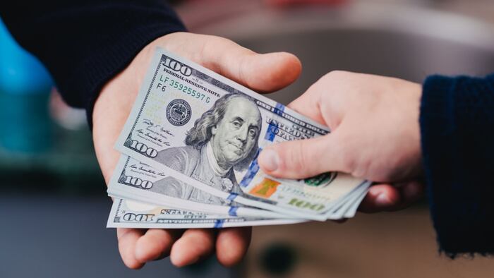 Transfer of money from hand to hand.